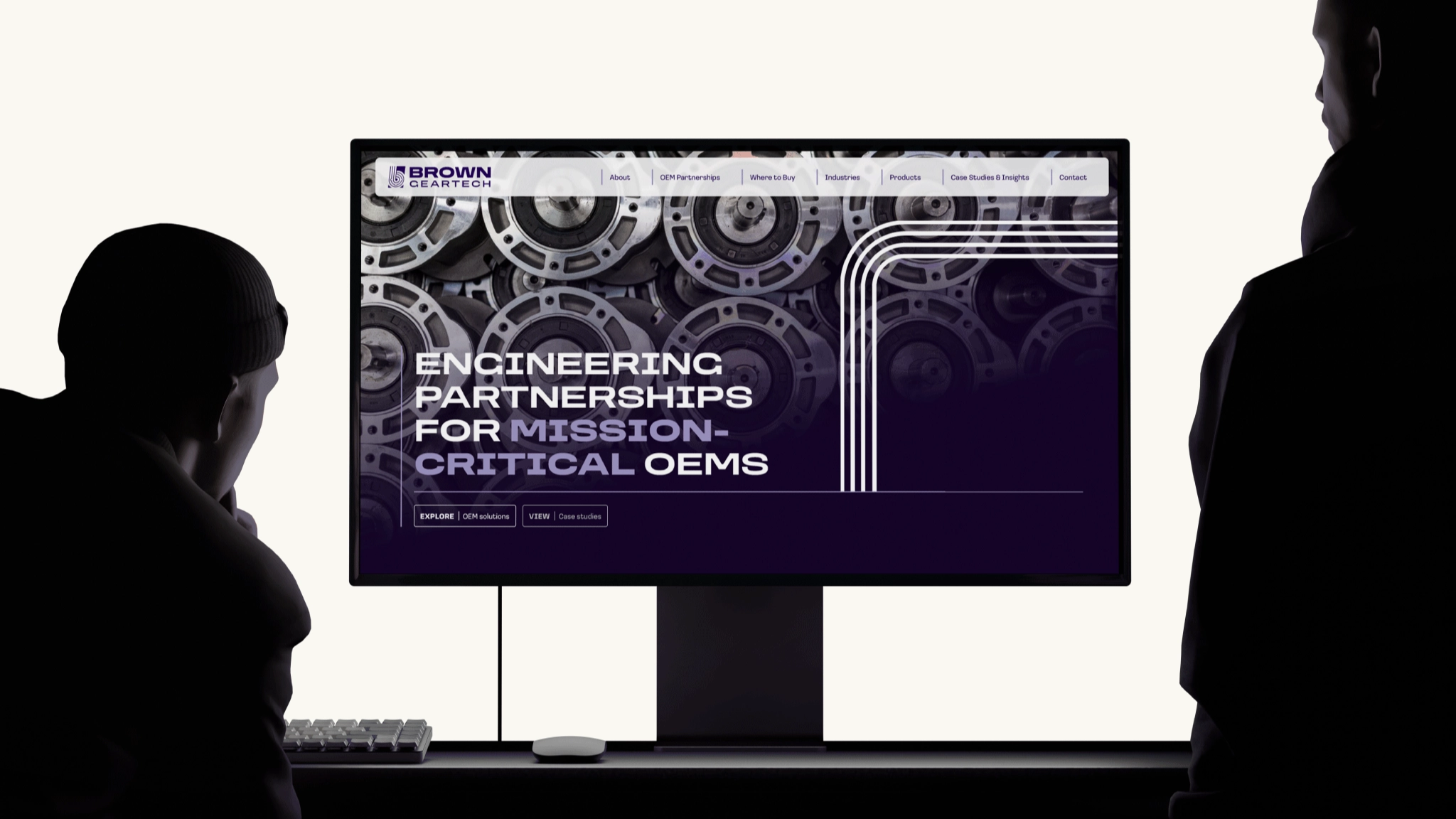 A stylised image of the Brown GearTech website displayed on a computer monitor with onlookers.