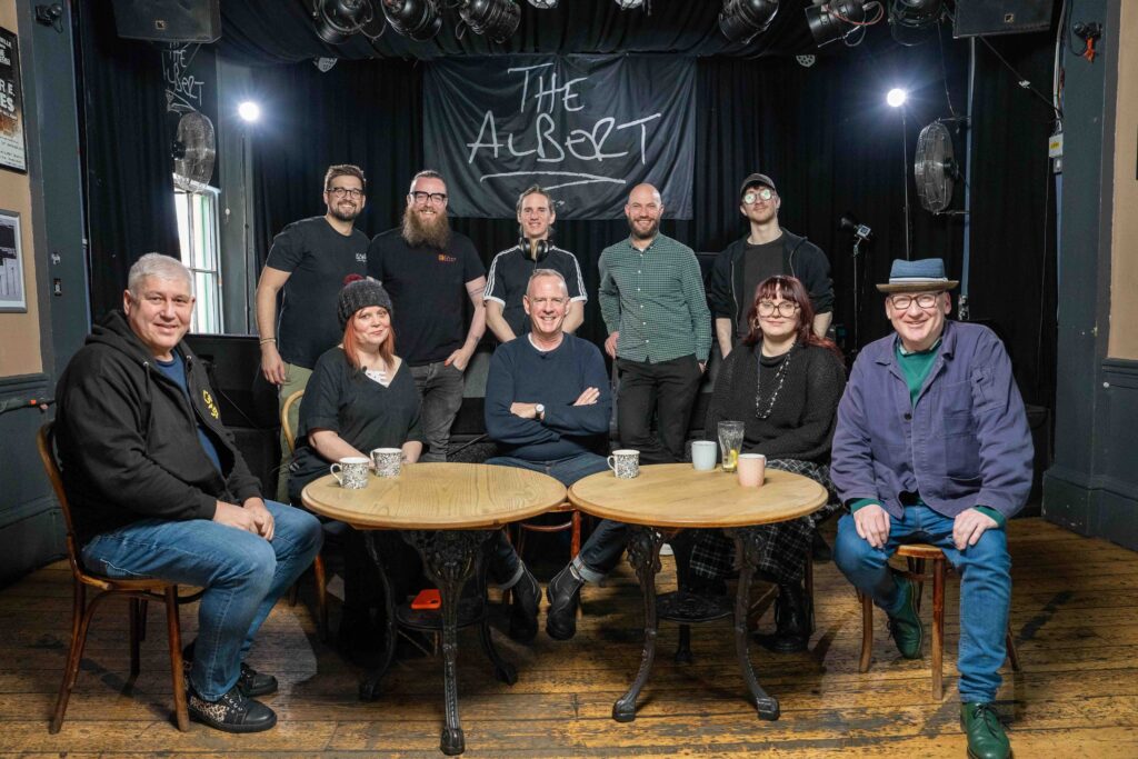 Left to right, front row: Thomas Evrenos - The Pipeline, Sally Ann Oakenfold - The Hope & Ruin, Norman Cook (Fatboy Slim), Angel Harrington, Green Door Store & Rossi Bar, William Moore - The Prince Albert. Left to right, back row: Santiago Pilgrim - Videographer, Matt Lucas - DOP, Scott Watson - Sound Engineer, Joe de Kwant Stoner - CEO, Will Stockton - Runner.